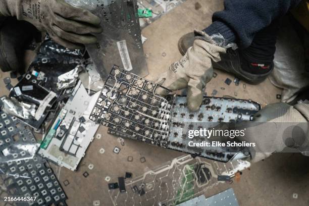 Workers dismantle electronic waste at E-Parisaraa on August 09, 2024 in Bengaluru, India. India is the third largest electronic waste producer in the...