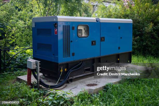 mobile backup diesel generator for uninterrupted power supply installed near private house outdoors - copia de seguridad fotografías e imágenes de stock