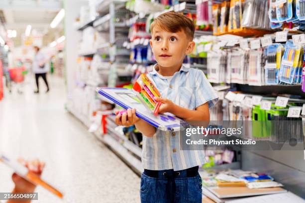 mother her son at stationery shopping in a store, his son is angry because he didn't get what he wanted - skolmaterial bildbanksfoton och bilder