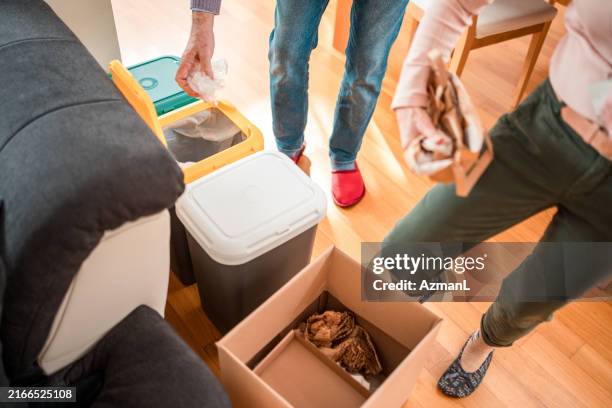 senior pair practicing sustainable living - disposal container stock pictures, royalty-free photos & images