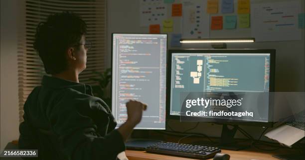 developer analyzing code on dual monitors. - java code stock pictures, royalty-free photos & images