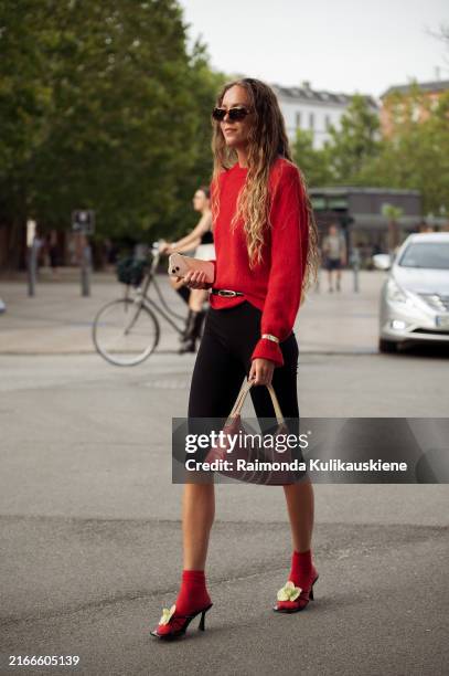 Guest wears outside the Baum und Pferdgarten show during day three of the Copenhagen Fashion Week SS25 on August 07, 2024 in Copenhagen, Denmark.