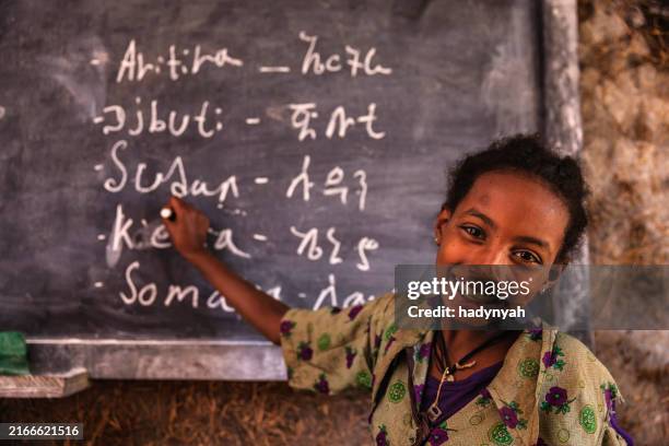 african little girl is learning amharic language - ethiopia stock pictures, royalty-free photos & images