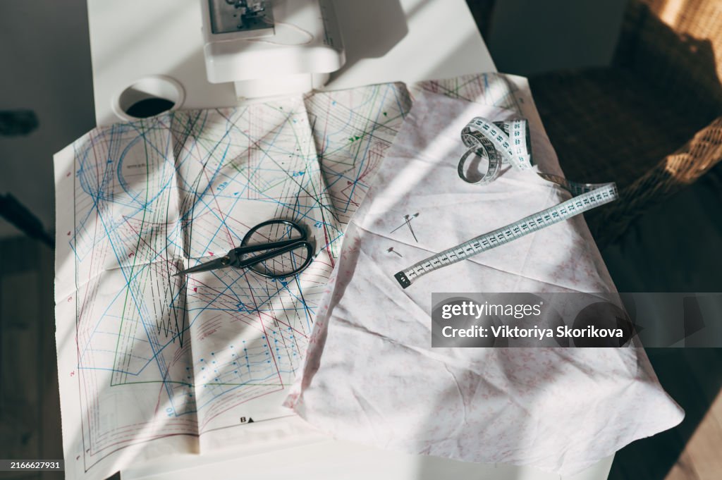 Seamstress female hands holding and stitching yellow textile fabric on modern sewing machine at workplace. Sewing process, upholstery, clothes, repair, DIY. Handmade, hobby, small business concept