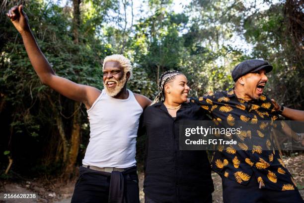 happy friends walking and talking on public park - social wellbeing stock pictures, royalty-free photos & images