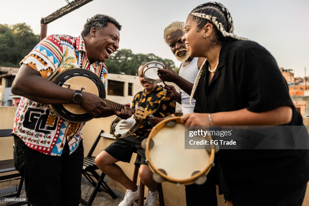 Friends playing instruments on rooftop party