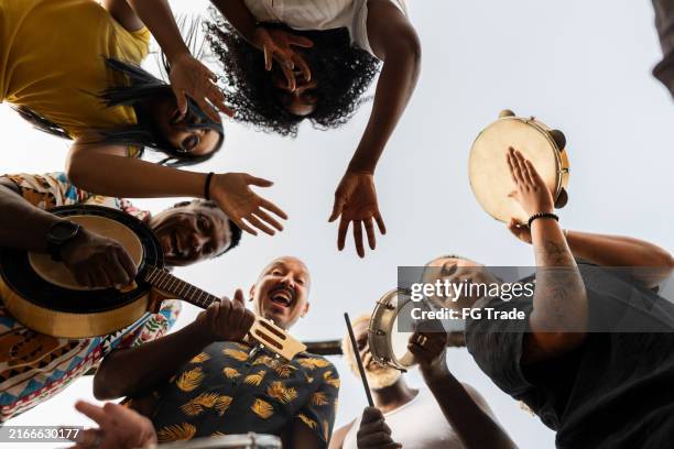 portrait of friends playing instruments outdoors - tambourine player stock pictures, royalty-free photos & images