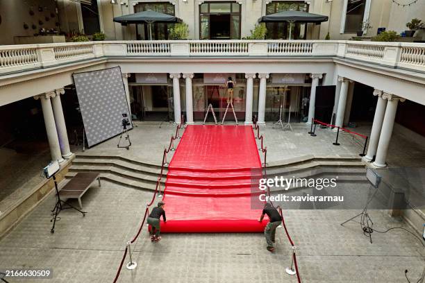setting up red carpet area for entertainment event - rope barrier stock pictures, royalty-free photos & images