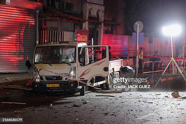 Israeli security and emergency personnel deploy at the site of an explosion in Tel Aviv on August 18, 2024. Palestinian groups Hamas and Islamic...