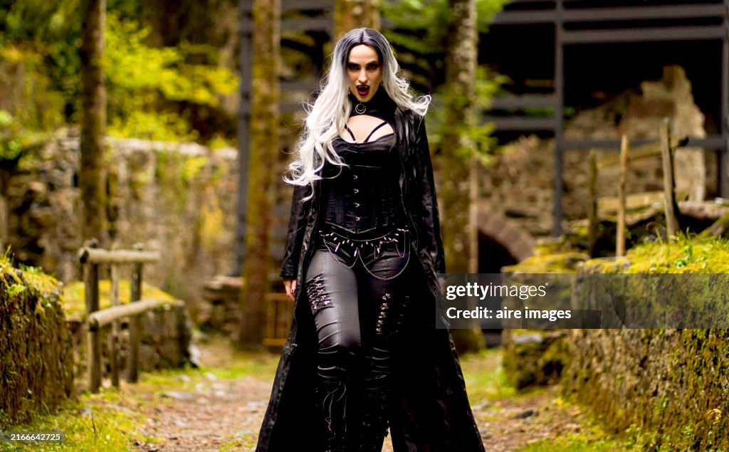 Woman in vampire costume outdoors.