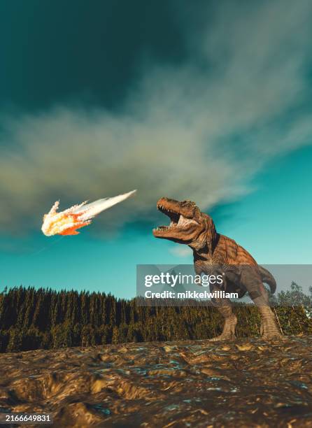 dinosaur’s defiance: roaring at the meteor of destruction - jurássico imagens e fotografias de stock