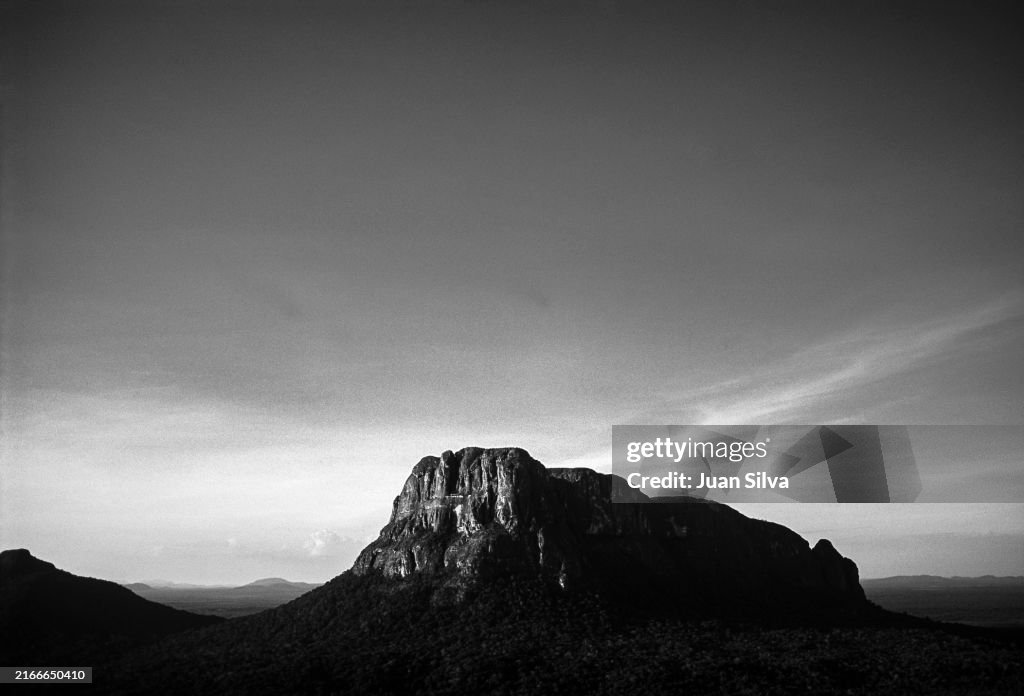 Aerial view of Wichuj and Uripicay tepuys or mountains in the middle of the Amazonas forest with rain storm at sunset, Amazonas state, Venezuela