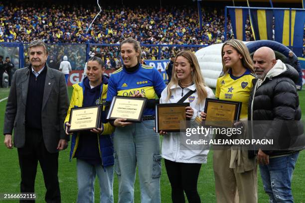 Former Colombian player Mauricio "Chicho" Serna , member of the Boca Juniors Football Council, presents a recognition to the players of Argentina's...