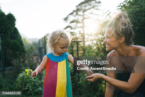 Mother and baby girl play in back yard Mother and baby girl play in back yard