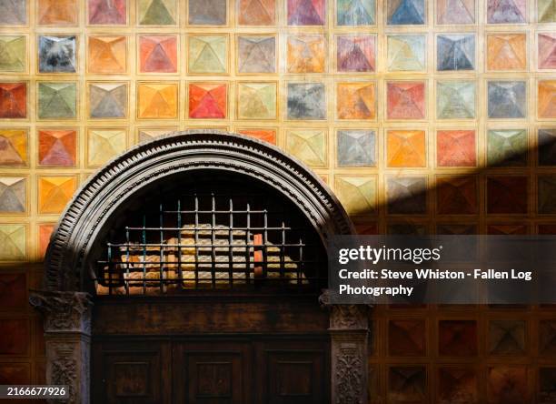 colorful painted mosaic pattern painted on the exterior of a building and around the doorway in old town of verona, italy - verona italy stock pictures, royalty-free photos & images