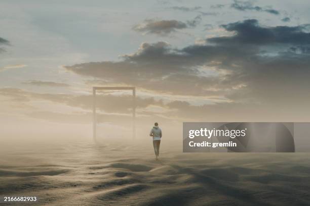 hombre joven que camina en un paisaje de fantasía hacia una entrada misteriosa - un solo hombre fotografías e imágenes de stock