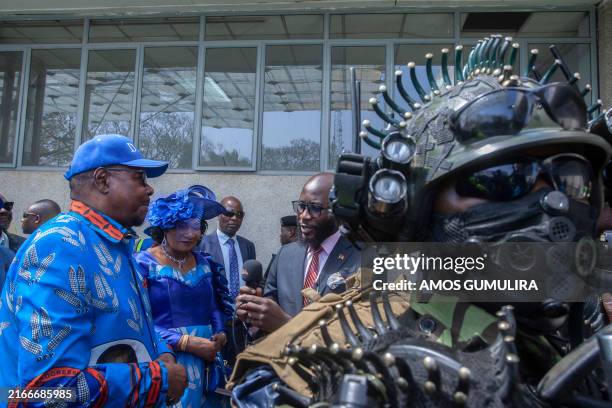Malawi's former president Professor Arthur Peter Mutharika speaks to the press as a mamber of security stands by during his Democratic Progressive...