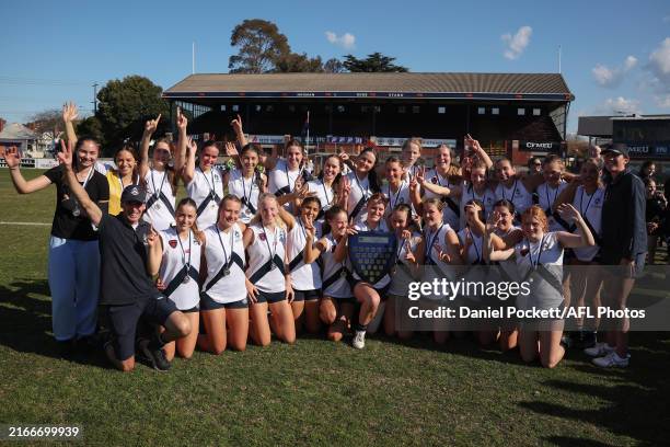 Melbourne Girls Grammar celebrate with the shield after winning the Herald Sun Shield Senior Girls Div 1 Grand Final match between Melbourne Girls...