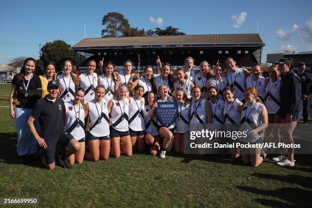 Melbourne Girls Grammar celebrate with the shield after winning the Herald Sun Shield Senior Girls Div 1 Grand Final match between Melbourne Girls...
