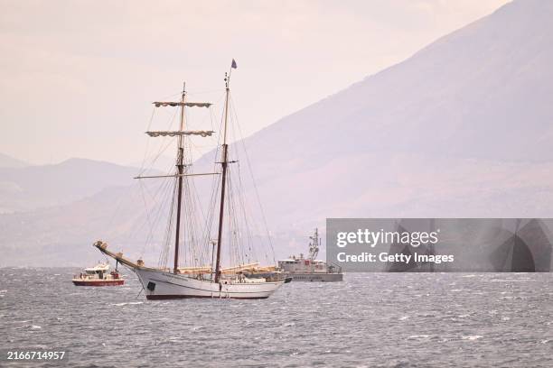 Coast guard vessel and a private sail boat assist the search for missing passengers after a yacht capsized on August 19, 2024 off the coast of...