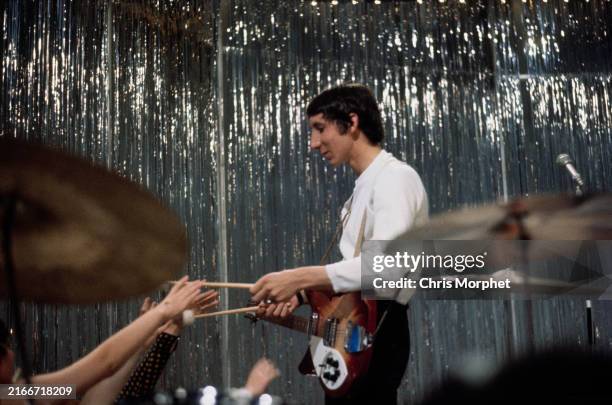 Guitarist Pete Townshend gives drum sticks to fans after their performance on BBC music show 'Top of the Pops,' at Lime Grove Studios in Shepherd's...