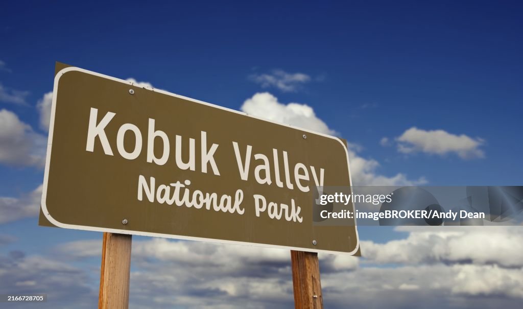 Kobuk valley national park (alaska) road sign against blue sky and clouds