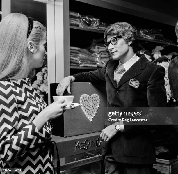 Fashion designer Yves Saint Laurent, right, in his boutique with actress Catherine Deneuve, Paris, September 27th 1966.