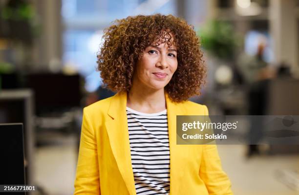 portrait of creative designer standing in modern office - yellow suit stock pictures, royalty-free photos & images