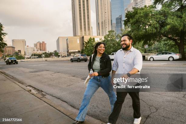 interracial couple hanging out in houston - couple crossing street stock pictures, royalty-free photos & images