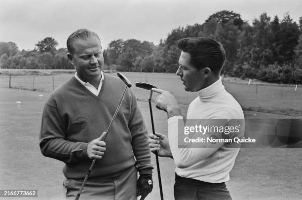 Golfers Jack Nicklaus, left, and Gary Player, holding up putters during practice at the World Match Play Championship, Wentworth Club, Virginia...