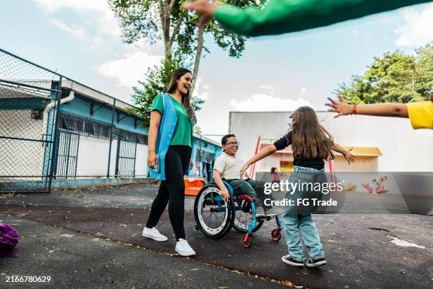 students greeting on schoolyard - disabled child playground stock pictures, royalty-free photos & images