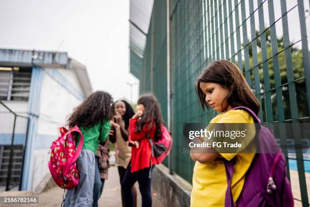 schoolgirl suffering bullying on school - bullying stock pictures, royalty-free photos & images