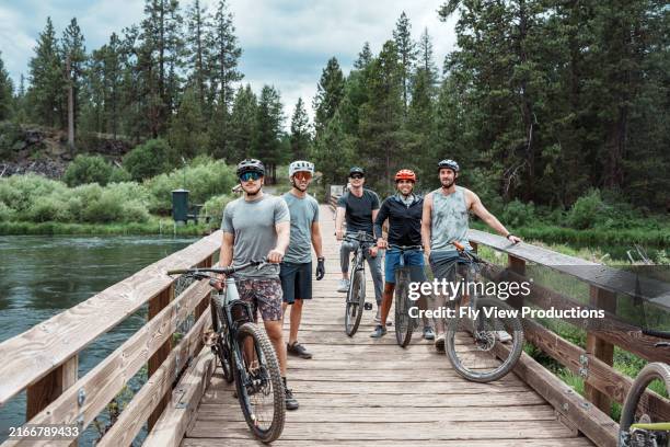 male friends pose for a picture while riding their bikes - trilho para bicicleta desporto ao ar livre imagens e fotografias de stock