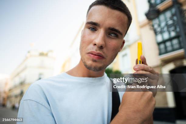 blind young man uses smartphone with artificial intelligence adapted for accessibility - accessibility blind stock pictures, royalty-free photos & images
