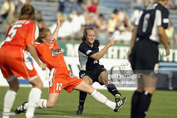 Midfielder Krista Davey of the New York Power passes the ball while pressured by defender Michelle French of the San Jose CyberRays during their WUSA...