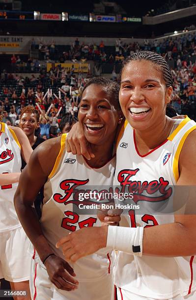 Tamika Catchings and Natalie Williams of the Indiana Fever celebrate after defeating the New York Liberty in the WNBA game at Conseco Fieldhouse on...