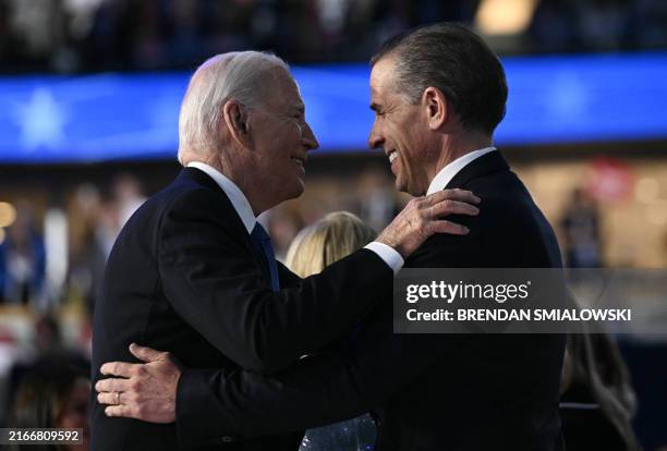 President Joe Biden and his son Hunter Biden hug on stage at the conclusion of the first day of the Democratic National Convention at the United...
