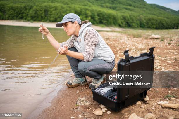 river ecology fieldwork with mobile lab. freshwater conservation. - water sample stock pictures, royalty-free photos & images