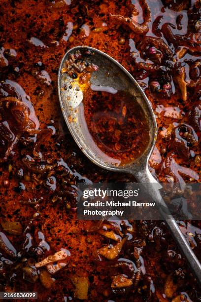 chilli oil and spoon - chili oil stock pictures, royalty-free photos & images