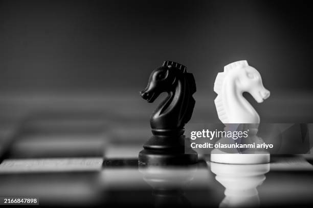 magnified miniature chess pieces - chess board stock pictures, royalty-free photos & images