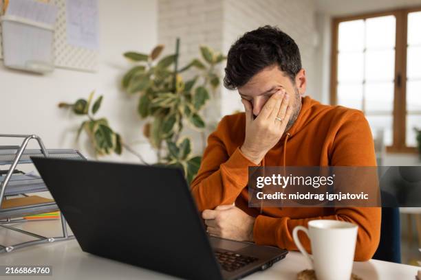 man tired after working at home - stressed man fotografías e imágenes de stock