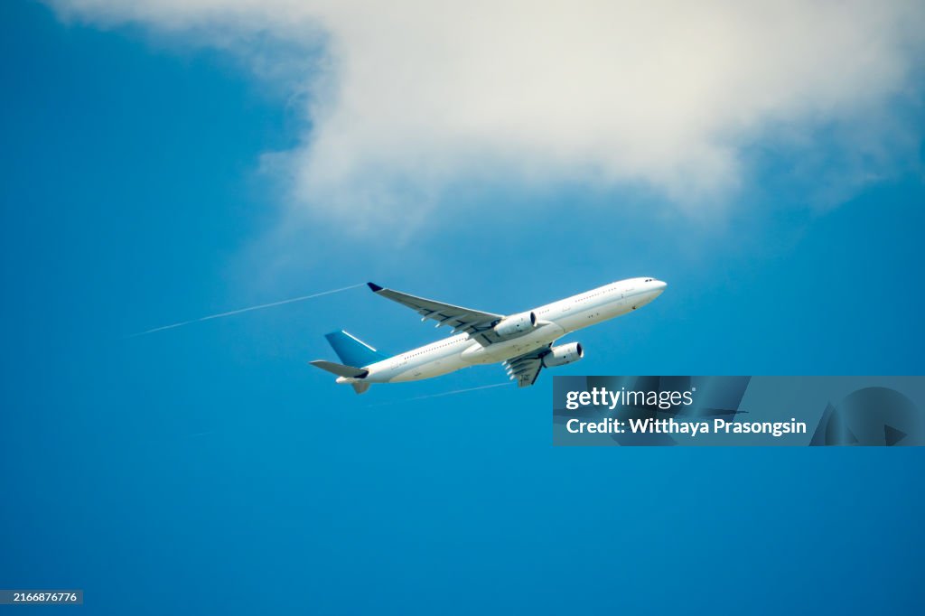 Passenger jet airplane over clouds