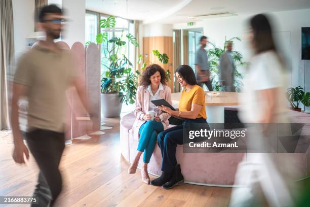 diverse female colleagues engage in creative process at office - rörelse bildbanksfoton och bilder