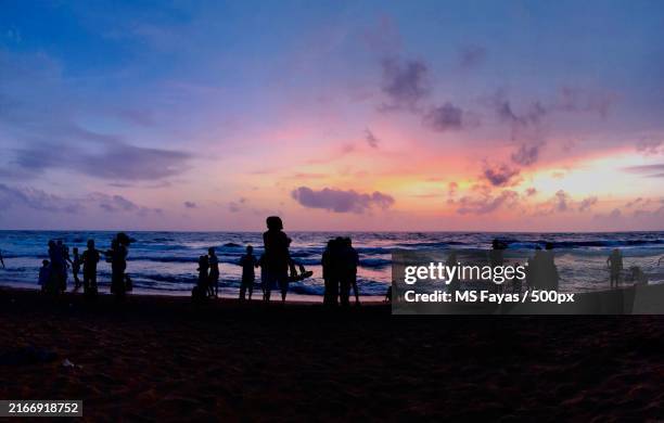silhouette of people at beach against sky during sunset,colombo,western province,sri lanka - colombo stock pictures, royalty-free photos & images