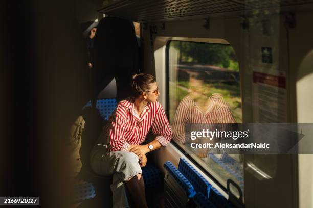woman on a train - carruagem imagens e fotografias de stock