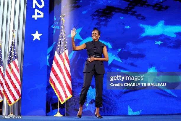 Former US First Lady Michelle Obama arrives to speak on the second day of the Democratic National Convention at the United Center in Chicago,...