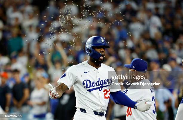 Pinch hitter Jason Heyward of the Los Angeles Dodgers is showered by sun flower seeds after hitting a three run home run during the eighth inning...