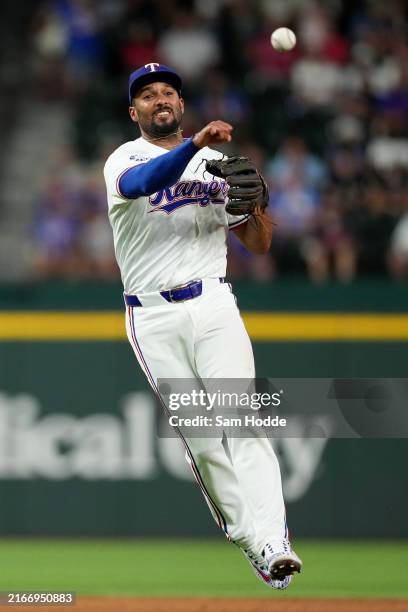 Marcus Semien of the Texas Rangers throws to first during the fifth inning against the Minnesota Twins at Globe Life Field on August 15, 2024 in...