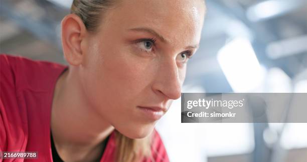 close-up of young woman on sports track - determination stock pictures, royalty-free photos & images