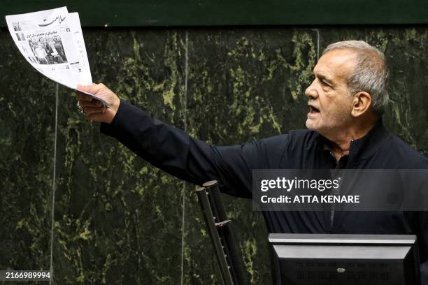 Iran's President Masoud Pezeshkian addresses parliament during a session to approve his new cabinet appointments in Tehran on August 21, 2024.